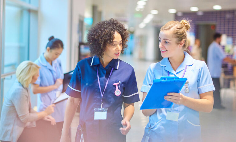 nurses talking in a hospital hallway