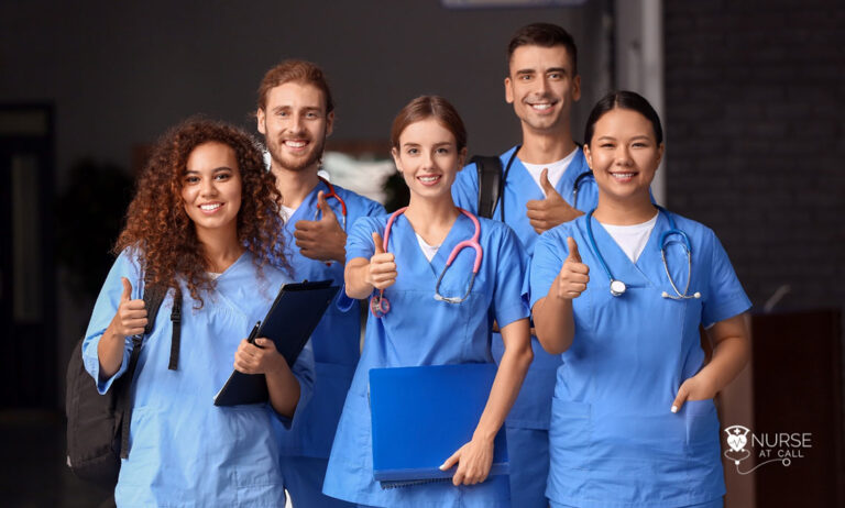 a group of travel nurses smiling with their thumbs up
