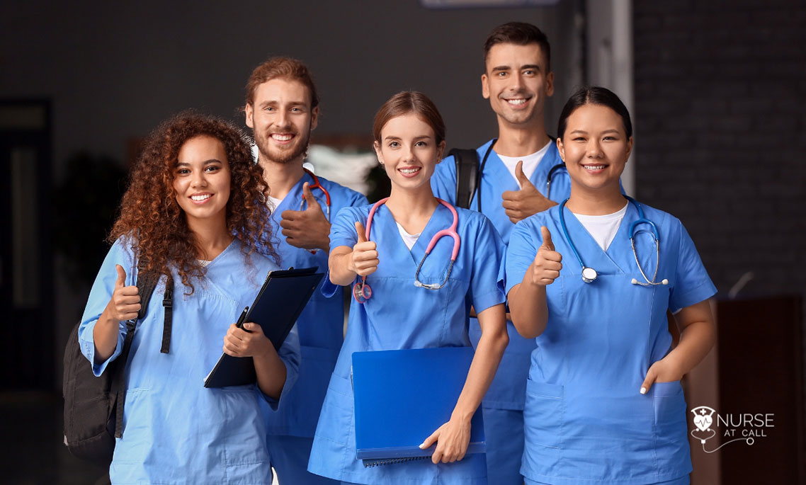 a group of travel nurses smiling with their thumbs up